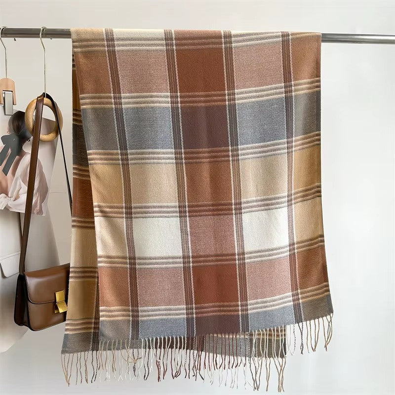 Écharpe plaid écossais marron et beige suspendue à un portant